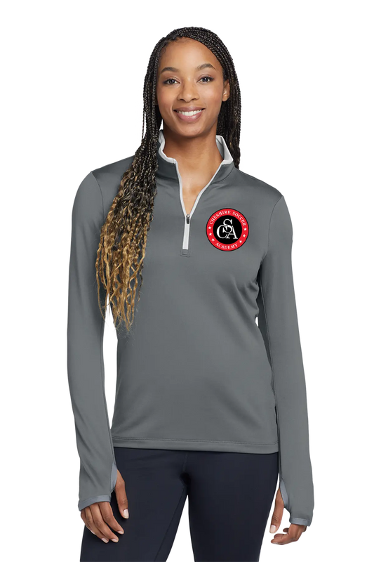 Woman wearing a gray long-sleeve shirt with a logo on a white background. Paper Street Print Co, Blairstown, NJ.