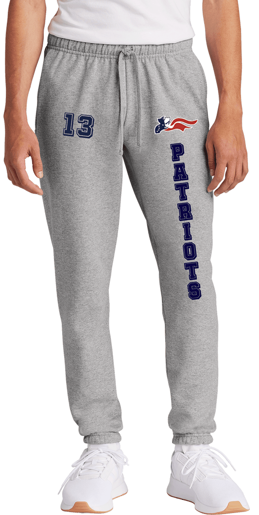 A pair of gray fleece sweatpants with 'Patriots' written on the side in a blue and red color scheme, consistent with a sports team branding.