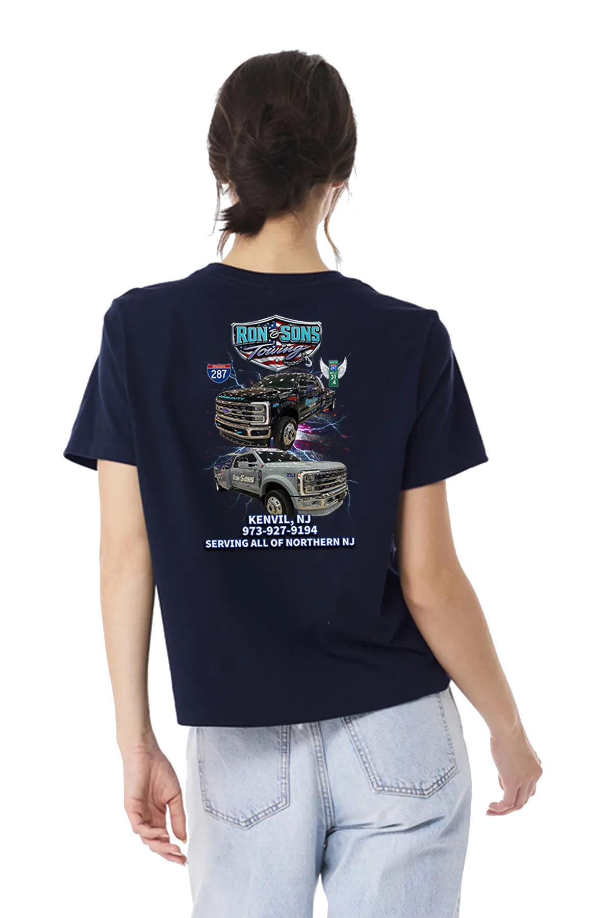 Person wearing a navy blue t-shirt with graphics and text on the back, standing against a white background. Ron and Sons Towing, Paper Street Print Co, Blairstown, NJ.