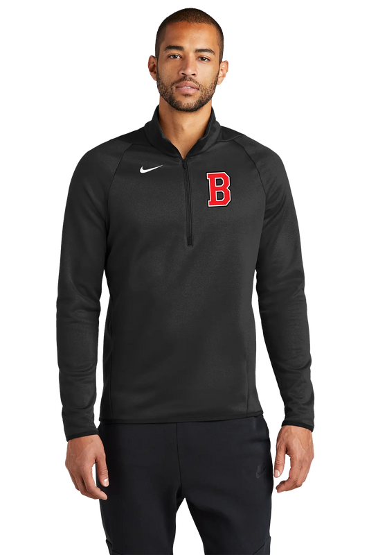 A man wearing a black Nike half-zip pullover with a red letter 'B' on the chest, photographed against a plain white background. Belvidere Lady Seaters Basketball, Paper Street Print Co, Blairstown, NJ.