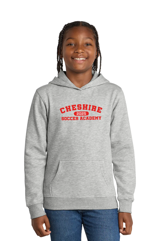 Girl wearing a gray hoodie with 'Cheshire Soccer Academy' text on a white background. Paper Street Print Co, Blairstown, NJ.