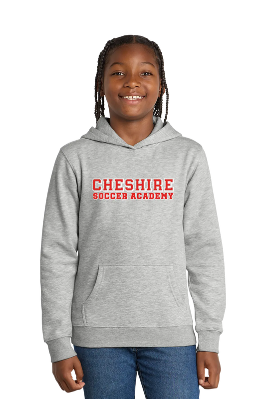 Girl wearing a gray hoodie with 'Cheshire Soccer Academy' text on a white background. Paper Street Print Co, Blairstown, NJ.