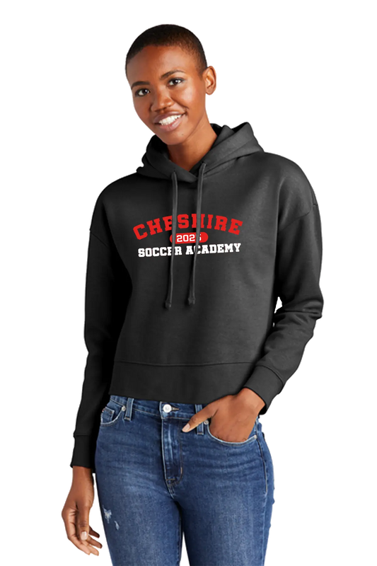 Person wearing a black hoodie with 'Cheshire Soccer Academy' text on a white background. Paper Street Print Co, Blairstown, NJ.