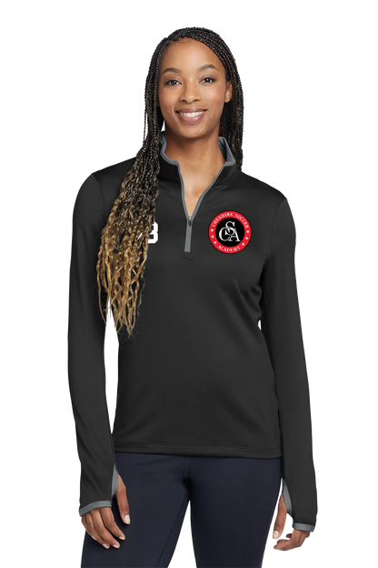 Woman wearing a black long-sleeve shirt with a logo on a white background. Paper Street Print Co, Blairstown, NJ.