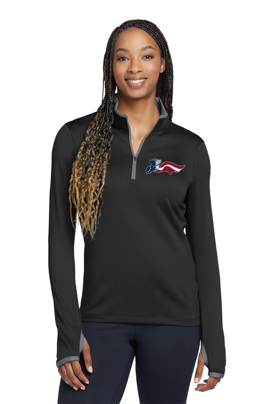 Woman wearing a black long-sleeve shirt with an American flag logo on a white background. Paper Street Print Co, Blairstown, NJ.