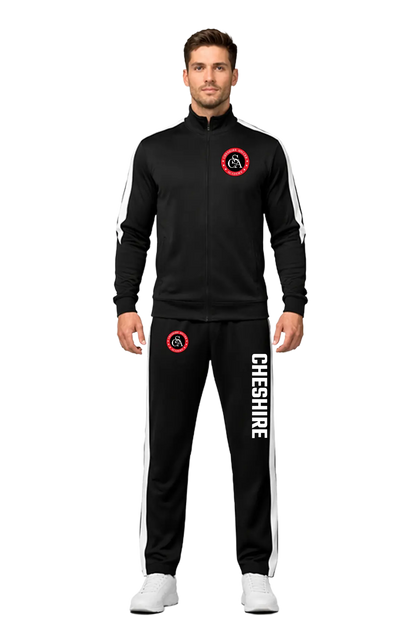 Man wearing a black tracksuit with 'Cheshire' branding on a white background. CSA Cheshire Soccer Academy, Paper Street Print Co, Blairstown, NJ.