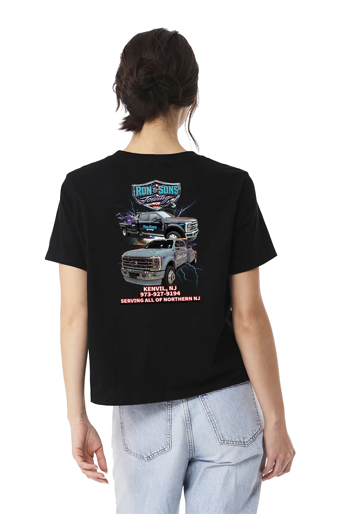 Person wearing a black t-shirt with graphics and text on the back, standing against a white background. Ron and Sons Towing, Paper Street Print Co, Blairstown, NJ.
