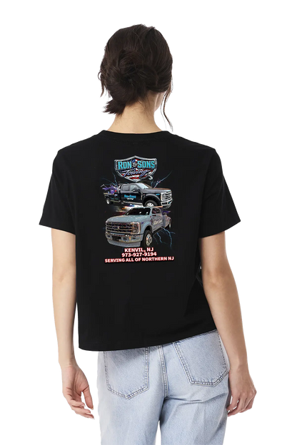 Person wearing a black t-shirt with graphics and text on the back, standing against a white background. Ron and Sons Towing, Paper Street Print Co, Blairstown, NJ.