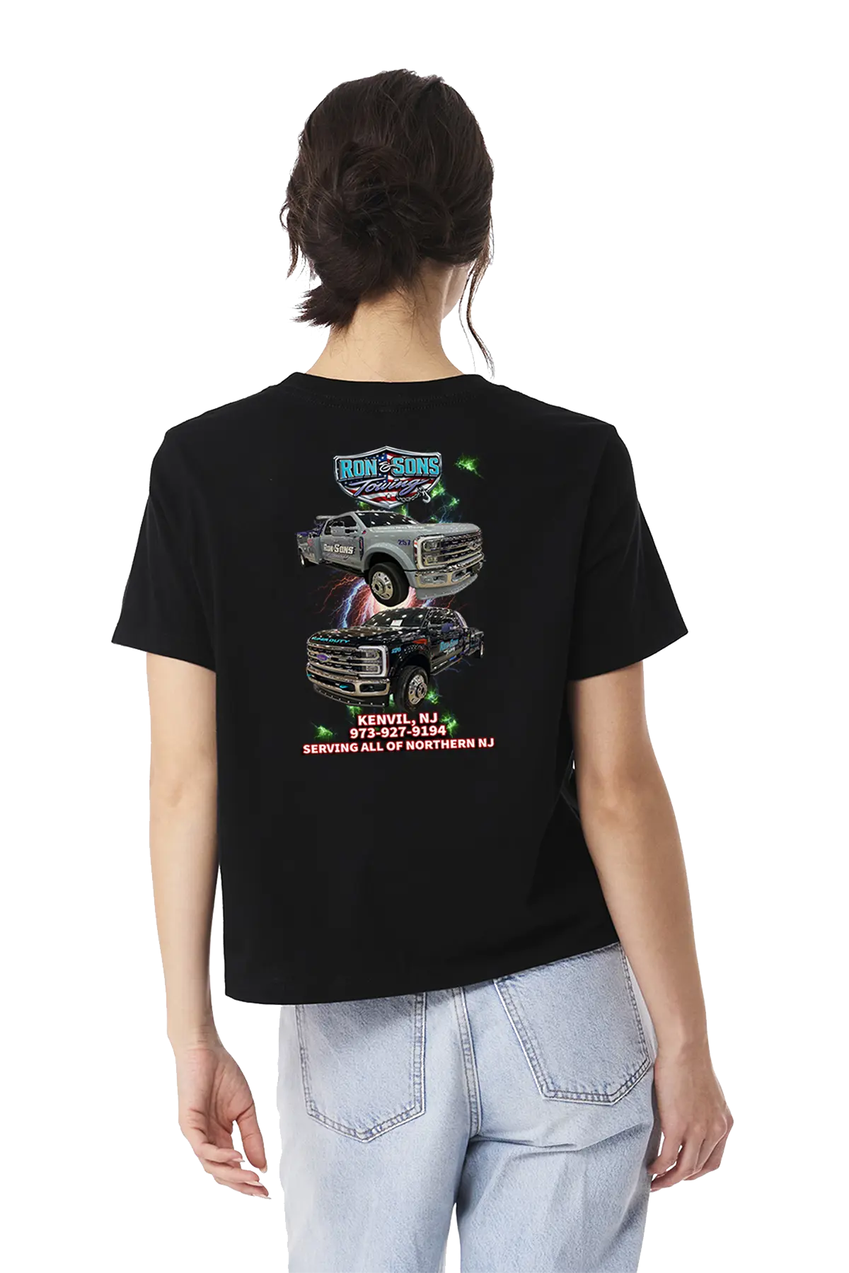 Person wearing a black t-shirt with graphic designs on the back, standing against a white background. Ron and Sons Towing, Paper Street Print Co, Blairstown, NJ.