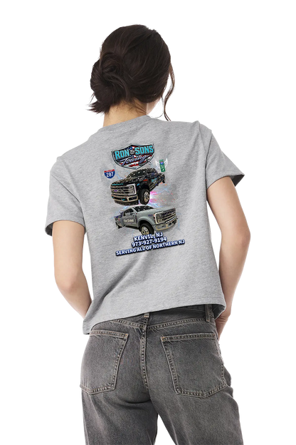 Person wearing a gray t-shirt with truck graphics on the back, standing against a white background. Ron and Sons Towing, Paper Street Print Co, Blairstown, NJ.