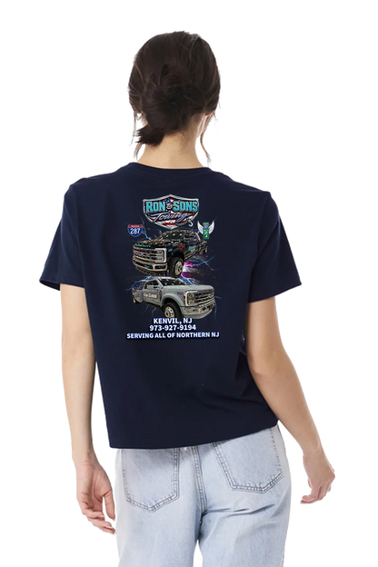 Person wearing a navy blue t-shirt with graphics and text on the back, standing against a white background. Ron and Sons Towing, Paper Street Print Co, Blairstown, NJ.