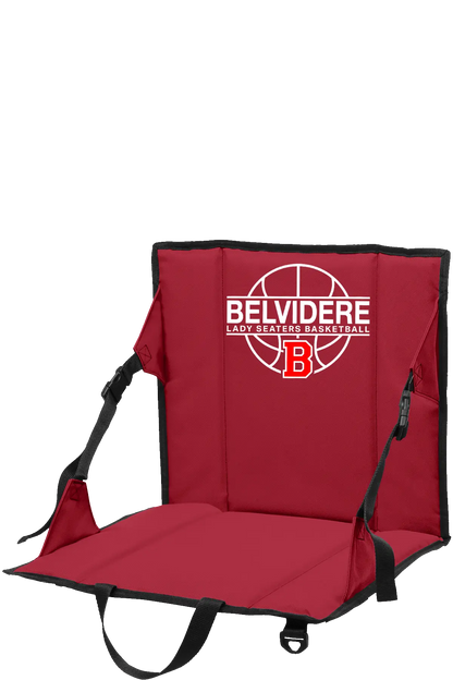 A red folding stadium chair with black straps and trim, featuring a white and red Belvidere Lady Seaters Basketball logo on the backrest, shown on a plain white background. Paper Street Print Co, Blairstown, NJ.