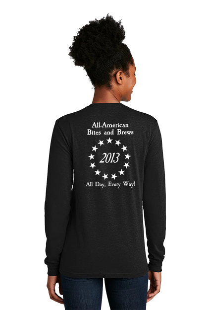 Person wearing a black long-sleeve shirt with text on the back, standing against a white background. Paper Street Print Co, Blairstown, NJ,