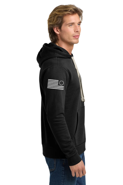Man wearing a black hoodie with a flag design on a white background. Paper Street Print Co, Blairstown, NJ.