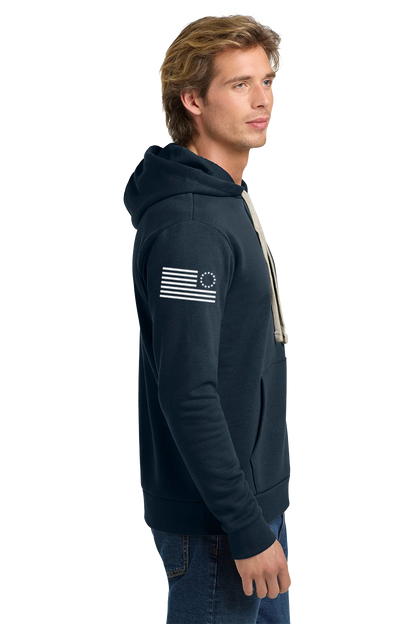 Man wearing a navy hoodie with a flag design on a white background. Paper Street Print Co, Blairstown, NJ.