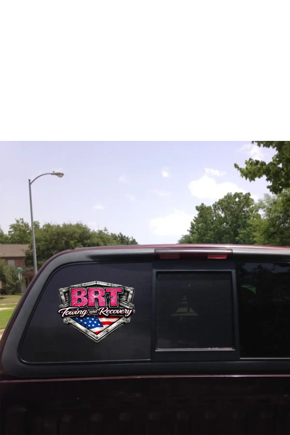 Back of a vehicle with a 'BRT Towing & Recovery' decal on a clear day. Paper Street Print Co, Blairstown, NJ.