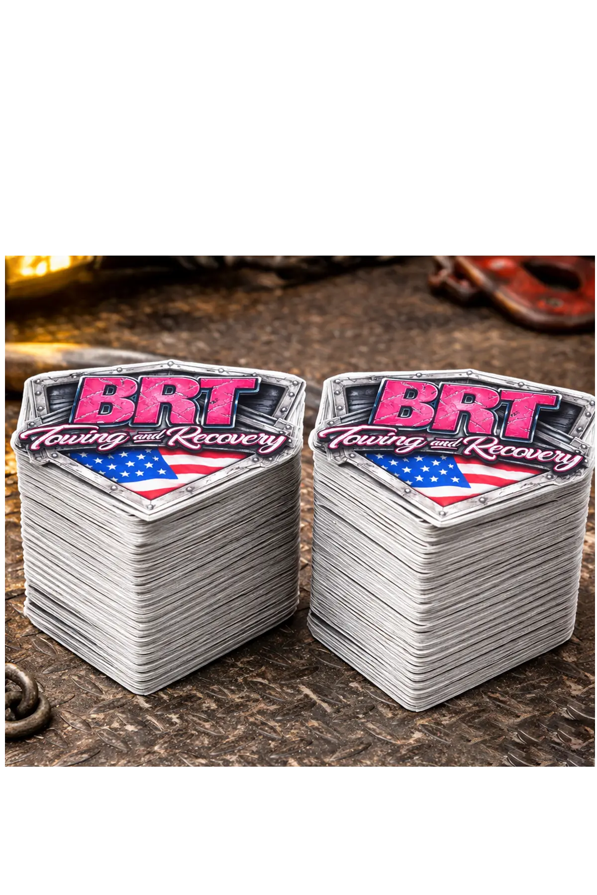 Two stacks of stickers with 'BRT' branding on a textured surface, stack of 100 stickers. Paper Street Print Co, Blairstown, NJ.