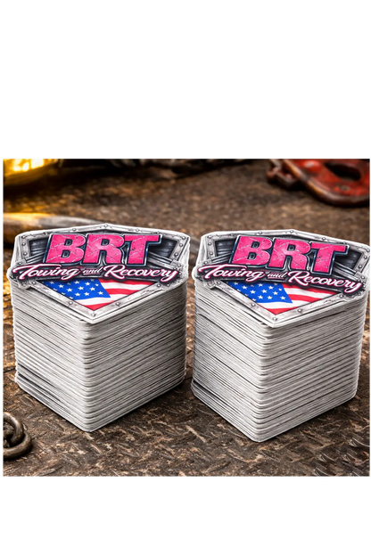 Two stacks of stickers with 'BRT' branding on a textured surface, stack of 100 stickers. Paper Street Print Co, Blairstown, NJ.
