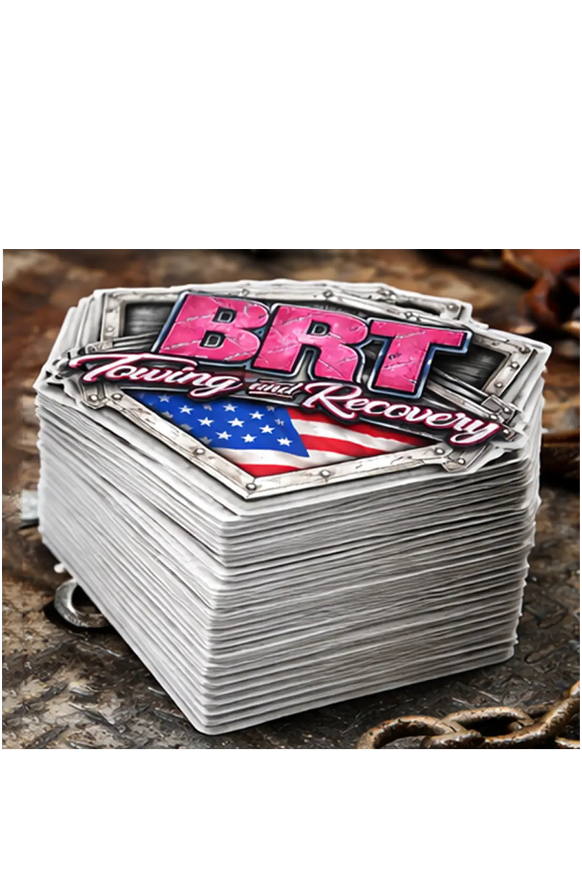 Stack of stickers with 'BRT Towing and Recovery' logo on a textured surface, stack of 50 stickers. Paper Street Print Co, Blairstown, NJ.