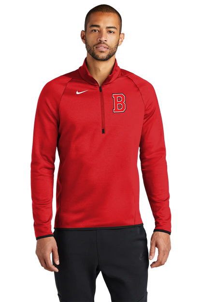 A man wearing a red Nike half-zip pullover with a white swoosh logo and a red letter 'B' on the chest, paired with black sweatpants, against a plain white background. Belvidere Lady Seaters Basketball, Paper Street Print Co, Blairstown, NJ.