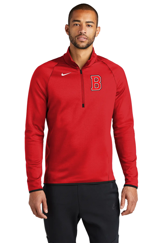 A man wearing a red Nike half-zip pullover with a white swoosh logo and a red letter 'B' on the chest, paired with black sweatpants, against a plain white background. Belvidere Lady Seaters Basketball, Paper Street Print Co, Blairstown, NJ.