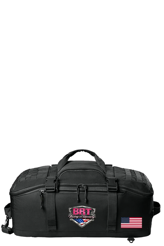 Black tactical bag with visible branding and an American flag on a white background. BRT Towing & Recovery, Paper Street Print Co, Blairstown, NJ.