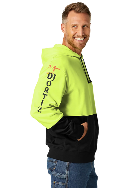 Man wearing a bright yellow and black hoodie with 'In Memory of DJ Ortiz' branding on a white background. #JUSTICEFORDJ - Paper Street Print Co, Blairstown, NJ.