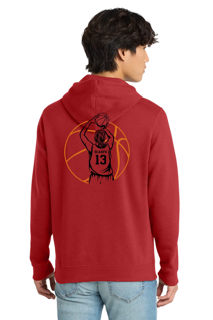 A man wearing a red pullover hoodie with a black and orange basketball graphic on the back, shown from behind against a plain white background. Belvidere Lady Seaters, Paper Street Print Co, Blairstown, NJ.