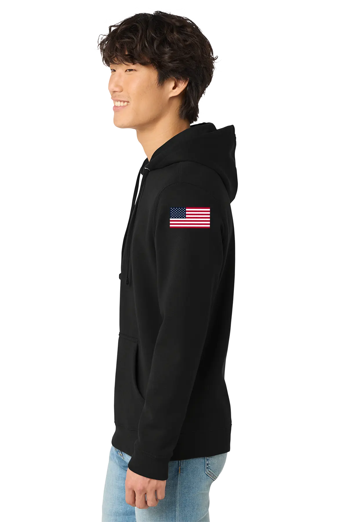 Person wearing a black hoodie with an American flag patch on the sleeve against a white background. BRT Towing & Recovery, Paper Street Print Co, Blairstown, NJ.