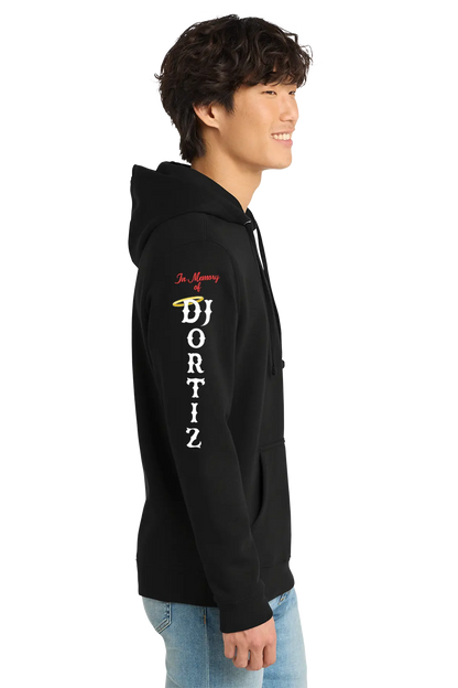 Person wearing a black hoodie with text and graphics on a white background. #JUSTICEFORDJ - Paper Street Print Co, Blairstown, NJ.