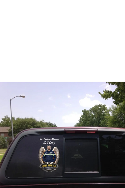 Car window with a memorial decal for DJ Otis, featuring an angelic figure and text. "In Loving Memory of DJ Ortiz" TOW Lives Matter, #JusticeforDJ - Paper Street Print Co, Blairstown, NJ.