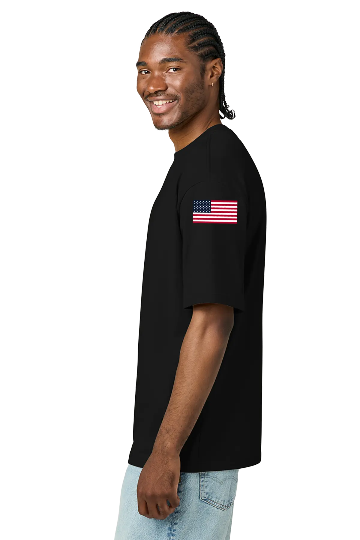 Man wearing a black t-shirt with an American flag on the sleeve against a white background. BRT Towing and Recovery, Paper Street Print Co, Blairstown, NJ.