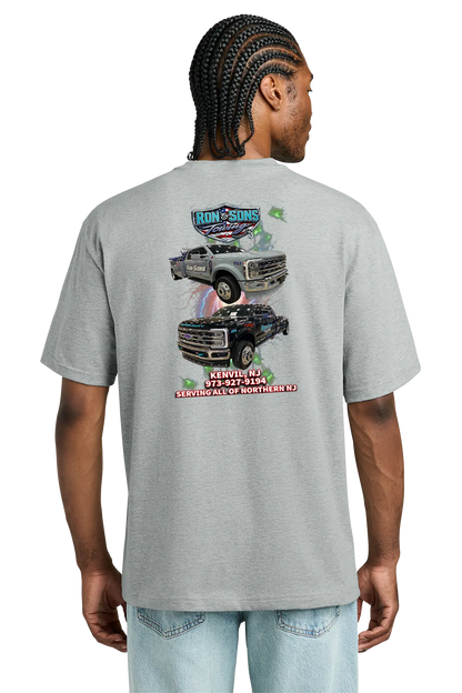 Person wearing a gray t-shirt with a graphic design on the back, featuring trucks and text. Ron and Sons Towing, Paper Street Print Co, Blairstown, NJ.