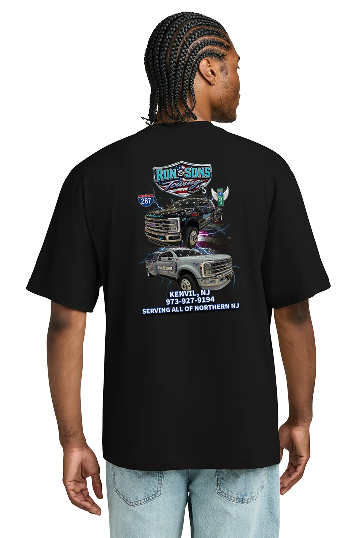 Person wearing a black t-shirt with graphics and text on the back, on a white background. Ron and Sons Towing, Paper Street Print Co, Blairstown, NJ.