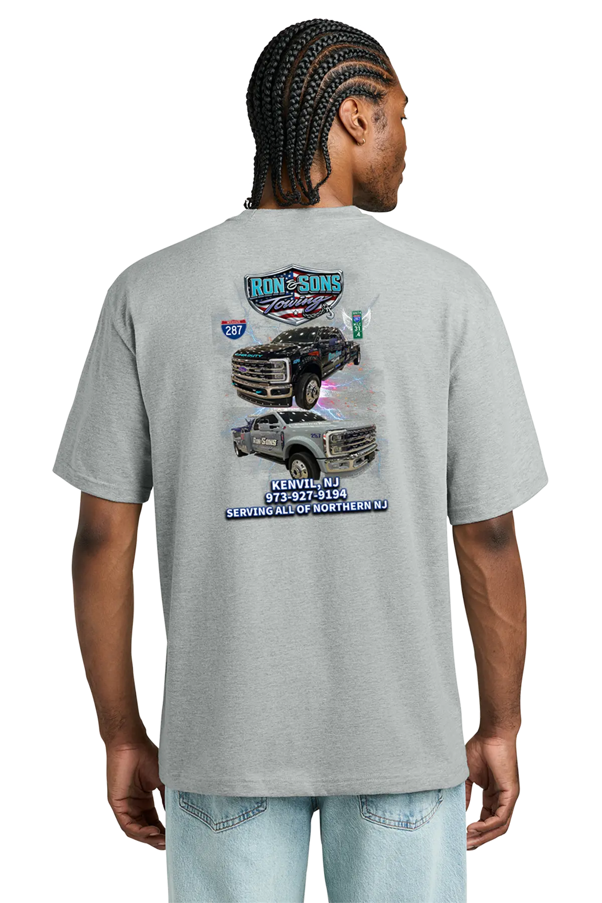 Person wearing a gray t-shirt with truck graphics on the back, standing against a white background. Ron and Sons Towing, Paper Street Print Co, Blairstown, NJ.