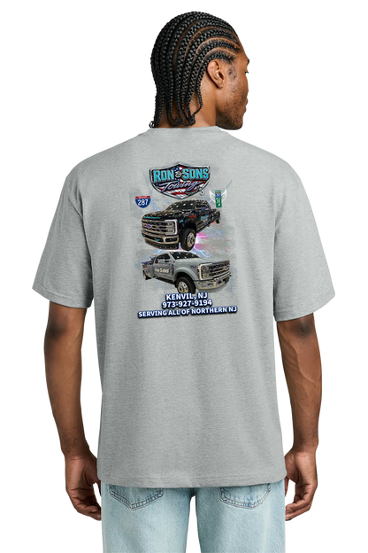 Person wearing a gray t-shirt with truck graphics on the back, standing against a white background. Ron and Sons Towing, Paper Street Print Co, Blairstown, NJ.