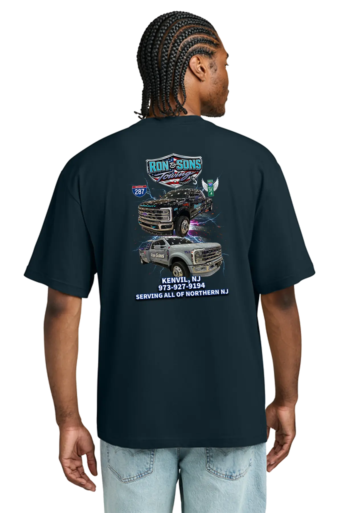 Person wearing a black t-shirt with graphics and text on the back, standing against a white background. Ron and Sons Towing, Paper Street Print Co, Blairstown, NJ.