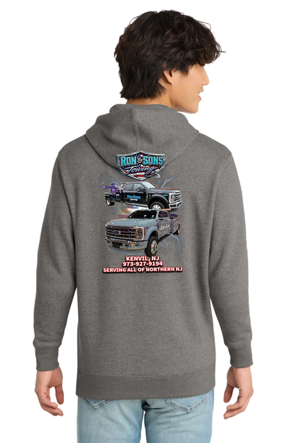 Person wearing a gray hoodie with a truck graphic and text on the back, standing against a white background. Ron and Sons Towing, Paper Street Print Co, Blairstown, NJ.