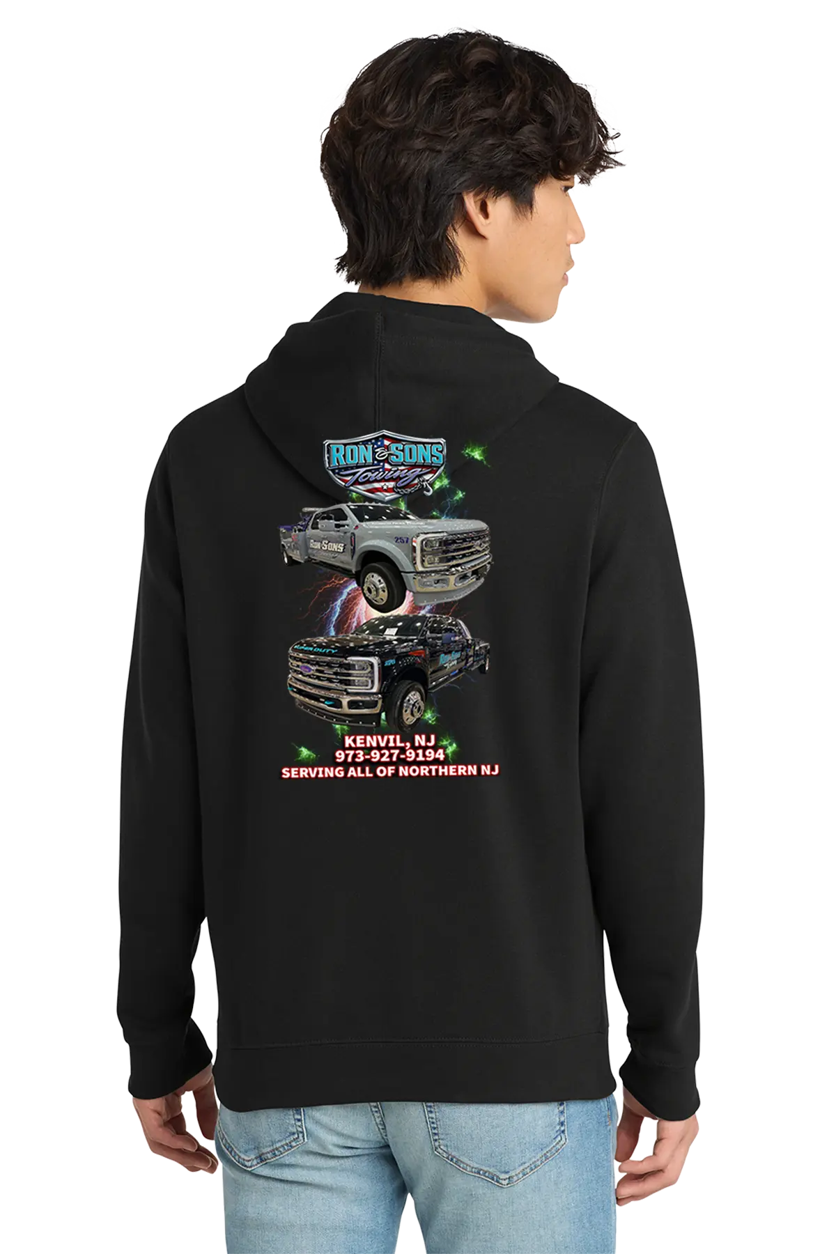 Person wearing a black hoodie with graphics on the back, standing against a white background. Ron and Sons Towing, Paper Street Print Co, Blairstown, NJ.