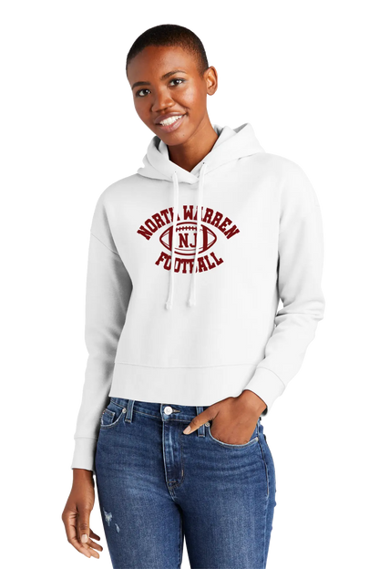 Woman wearing a white hoodie with 'Norty Warren Football' text, standing against a white background. Paper Street Print Co, Blairstown, NJ.