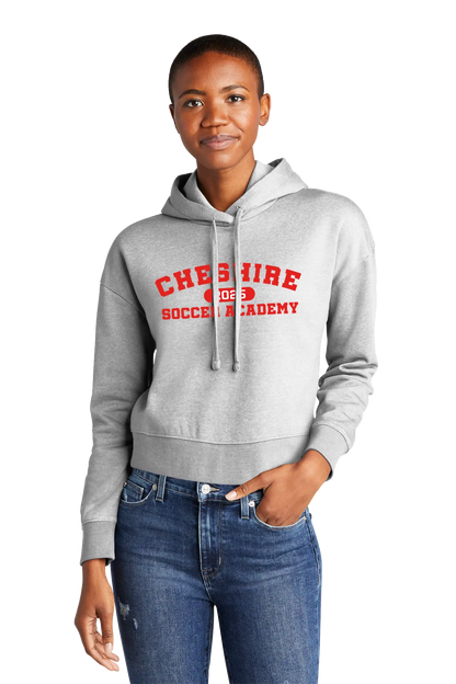 Person wearing a gray hoodie with red text and blue jeans on a white background. Paper Street Print Co, Blairstown, NJ.