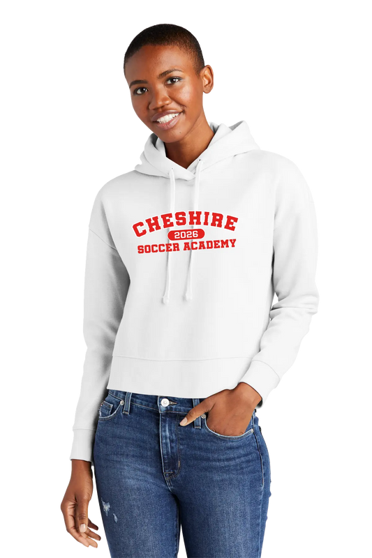 Person wearing a white hoodie with 'Cheshire Soccer Academy' text, standing against a white background. Paper Street Print Co, Blairstown, NJ.