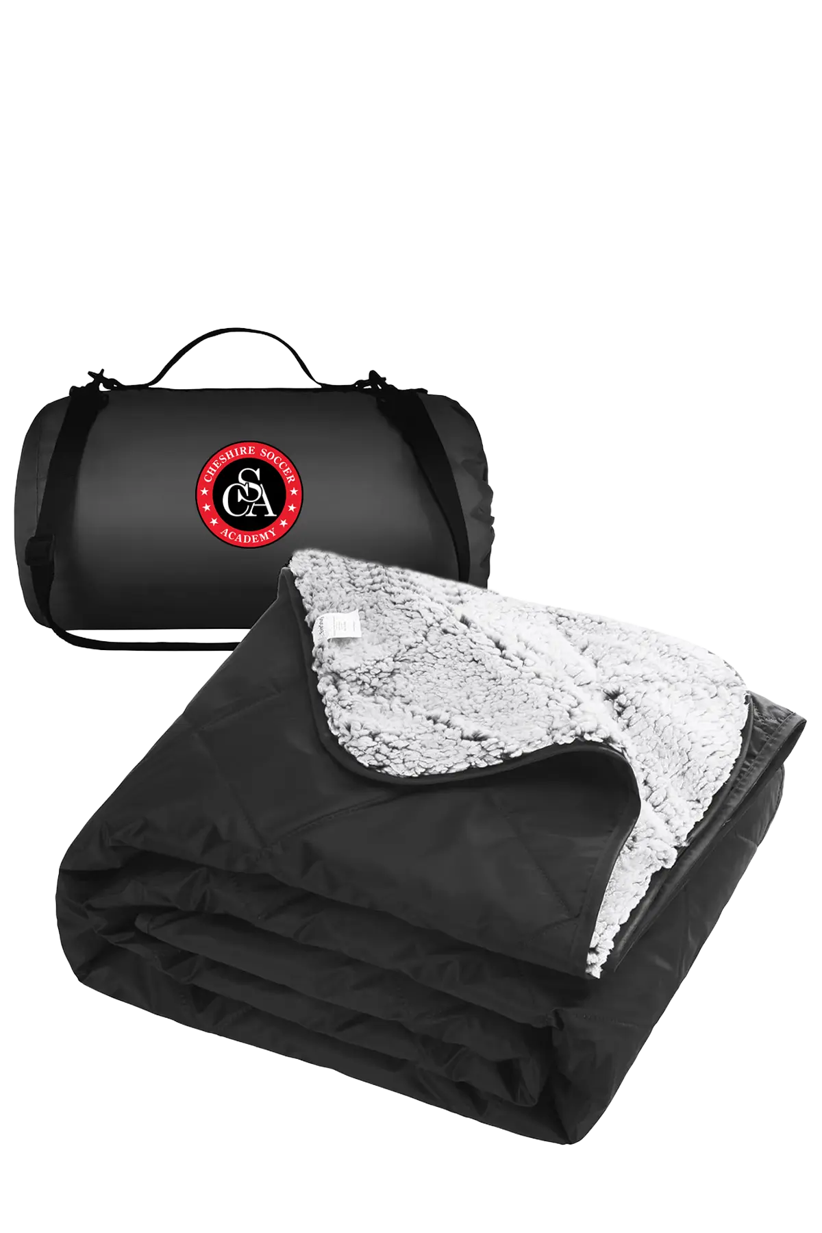 Black and white blanket with a carrying bag featuring a logo on a white background. CSA Cheshire Soccer Academy, Paper Street Print Co, Blairstown, NJ.