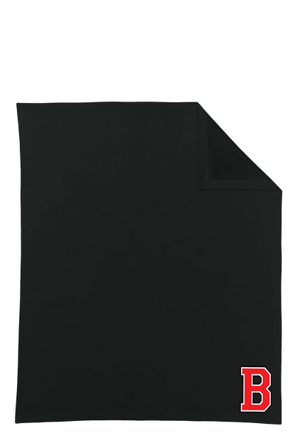 A black rectangular towel or blanket with a folded top-right corner, featuring a red block letter 'B' logo in the bottom-right corner, shown on a plain white background. Belvidere Lady Seaters Basketball, Paper Street Print Co, Blairstown, NJ.