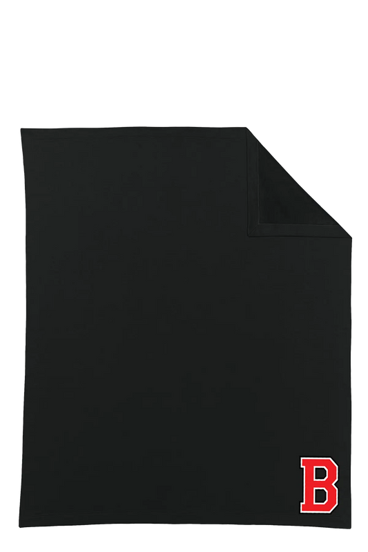 A black rectangular towel or blanket with a folded top-right corner, featuring a red block letter 'B' logo in the bottom-right corner, shown on a plain white background. Belvidere Lady Seaters Basketball, Paper Street Print Co, Blairstown, NJ.