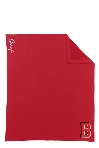A red square stadium blanker with a folded corner showing the reverse side, featuring a white script 'SCARFO' logo on the left and a red and white letter 'B' logo in the bottom right corner. Belvidere Lady Seaters Basketball, Paper Street Print Co, Blairstown, NJ.