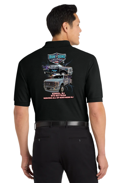 Person wearing a black work shirt with graphics and text on the back, standing against a white background. Ron and Sons Towing, Paper Street Print Co, Blairstown, NJ.