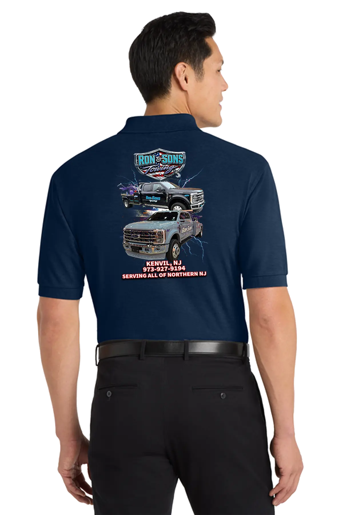 Man wearing a navy blue shirt with a graphic of trucks on the back, standing against a white background. Ron and Sons Towing, Paper Street Print Co, Blairstown, NJ.