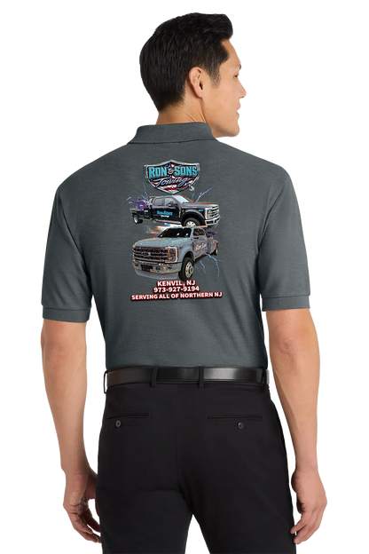 Person wearing a gray polo shirt with vehicle graphics and text on the back. Ron and Sons Towing, Paper Street Print Co, Blairstown, NJ.