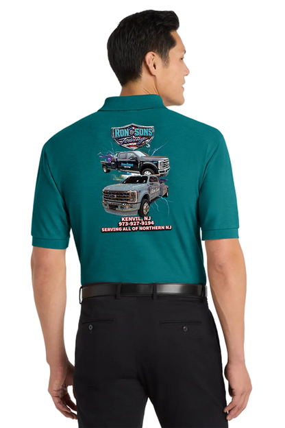 Man wearing a teal shirt with graphics and text on the back, standing against a white background. Ron and Sons Towing, Paper Street Print Co, Blairstown, NJ.